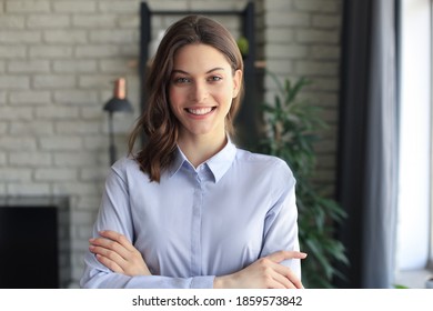 Attractive Business Woman Smiling While Standing In The Office.