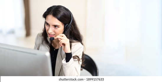 Attractive Business Woman In Suits And Headsets Are Smiling While Working With Computer At Office. Customer Service Assistant Working In One Stop Service Office