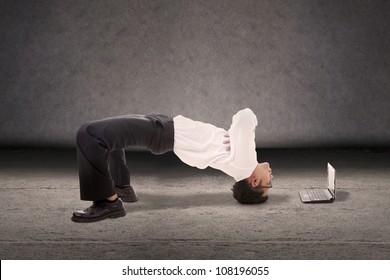 Attractive Businessman Doing Breakdance Style With Laptop Computer