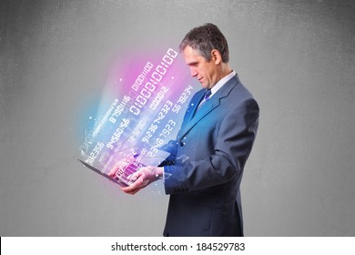 Attractive businessman holding notebook with exploding data and numbers