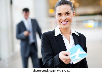 Attractive Businesswoman Handing Over Air Ticket At Airport Check In Counter