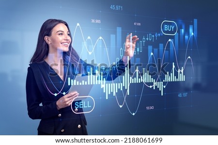 Attractive businesswoman wearing formal wear is standing holding tablet device touching digital interface with forex candlesticks and bar diagram. Concept of internet trading, shares purchase