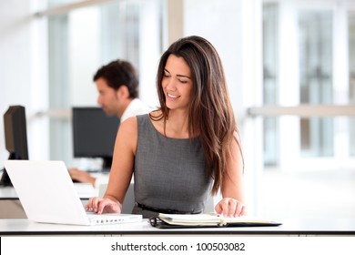 Attractive businesswoman working on laptop computer - Powered by Shutterstock