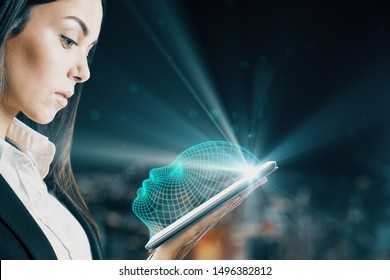 Attractive caucasian businesswoman holding tablet with glowing head outline on blurry night city background. AI and face ID concept. Double exposure 