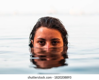 attractive Caucasian female getting out of swimming pool. Woman enjoying swimming in a pool. Woman in swimsuit having fun at the beach - Powered by Shutterstock