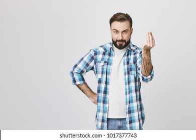 Attractive Caucasian Guy Looking Mad And Angry, Holding Hand On Waist While Showing Get To The Point Gesture With Another, Over Gray Background. Furious Landlord Says Time Is Up And Want His Money