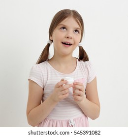 Attractive caucasian little girl and cosmetic creme - Shutterstock ID 545391082