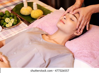 An attractive Caucasian woman getting massaged by a therapist. woman getting head and neck massage by therapist


