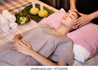 An attractive Caucasian woman getting massaged by a therapist. woman getting head and neck massage by therapist


