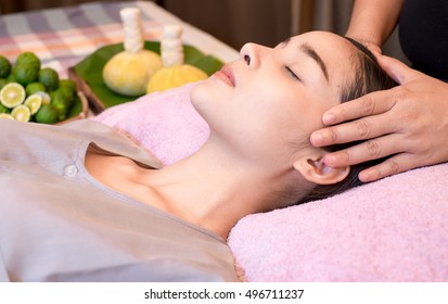 An attractive Caucasian woman getting massaged by a therapist. woman getting head and neck massage by therapist

