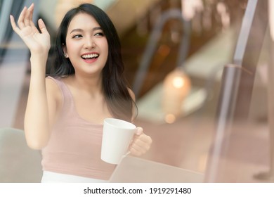 Attractive Cheerful Asian Female Adult Gesture Hand Wave To Say Hi To Her Friend Walking In Cafe Restaurant,asian Woman Hand Hold Coffee Cup Relax Casual In Cafe Shot Through Window Glass 