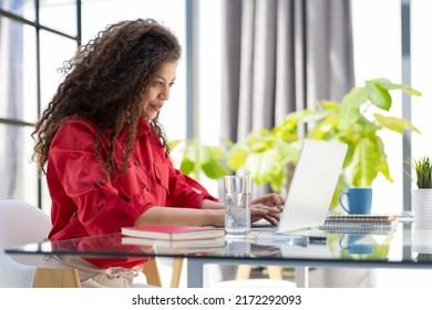 Attractive Cheerful Business Woman In Red Shirt Working On Laptop At Modern Office