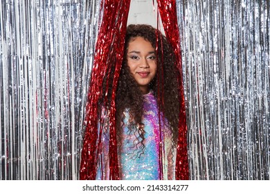 Attractive Cheerful Girl Having Fun And Good Mood While Posing Near Silver Tinsel Curtain