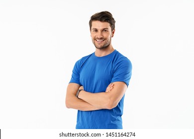 Attractive cheerful young fit sportsman wearing t-shirt standing isolated over white background, arms folded - Powered by Shutterstock