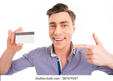 Attractive cheerful young man pointing on bank card