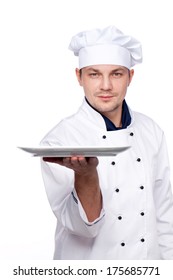 Attractive Chef In Uniform Holding Empty Plate On White Background