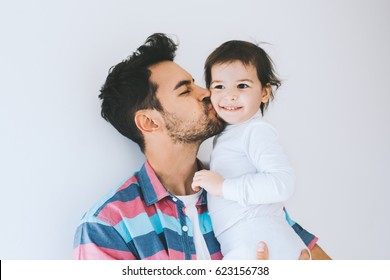 Attractive Close Up Portrait Of Hipster Father Kissing His Little Daughter. Young Dad Is Enjoying Time With His Child. Handsome Father With Little Girl. Happy Father And Daughter. Lifestyle Family.