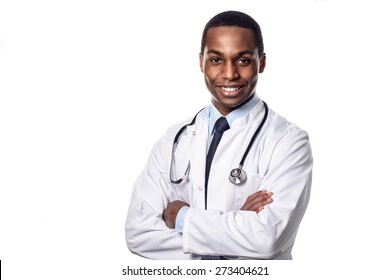 Attractive confident male African doctor wearing a white lab coat and stethoscope looking at the camera with a happy expression, upper body isolated on white