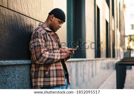 Similar – Attractive black man listening to music with earphones