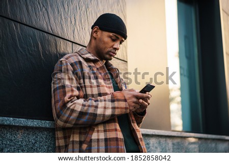 Similar – Attractive black man listening to music with earphones