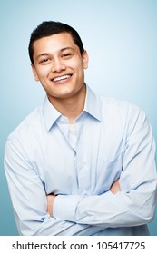 attractive confident young man smiling blue background