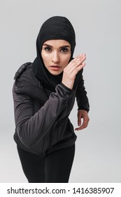 Attractive Confident Young Muslim Woman Wearing Sport Hijab Running Isolated Over White Background