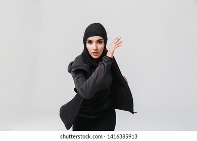 Attractive Confident Young Muslim Woman Wearing Sport Hijab Running Isolated Over White Background