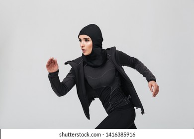 Attractive Confident Young Muslim Woman Wearing Sport Hijab Running Isolated Over White Background