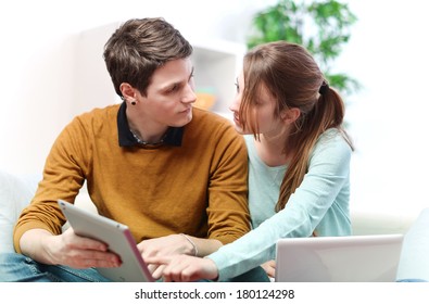 Attractive Couple Consulting Something On A Touchpad