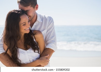 Attractive Couple Cuddling At The Beach