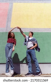 Attractive Couple Dancing Outside Near The Wall