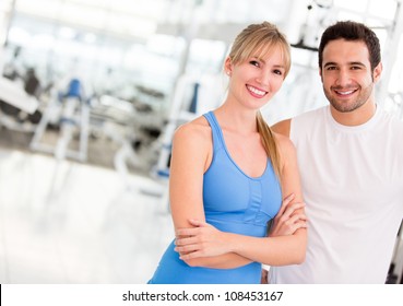 Attractive couple at the gym looking happy