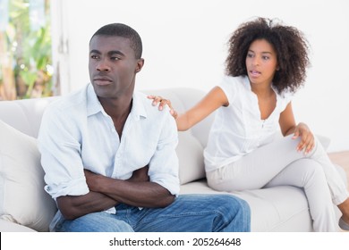 Attractive couple having an argument on couch at home in the living room