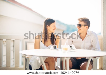 Attractive couple having first date.Blind date.Coffee with a friend.Smiling happy people having a coffee,dating.Getting to know each other.First romantic date,meeting new people after break up.