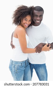 Attractive Couple In Matching Clothes Smiling At Camera On White Background