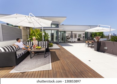 Attractive Couple On Luxurious Penthouse Balcony