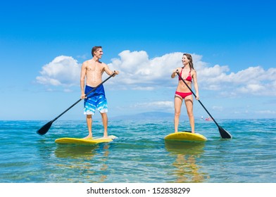 Attractive Couple Stand Up Paddling in Hawaii