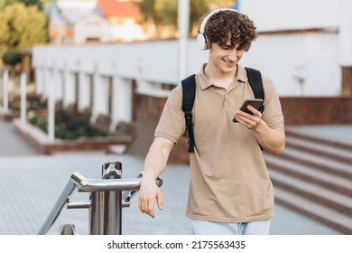 Attractive Curly Young Man University Or College Student With Phone Walking Around Campus