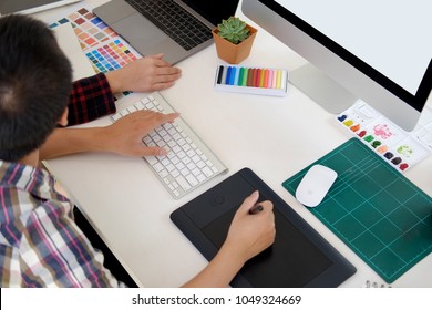 Attractive designer team working with digital tablet at design studio office.
