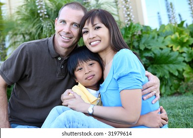 Attractive Diverse Family Outside Their Home On Porch