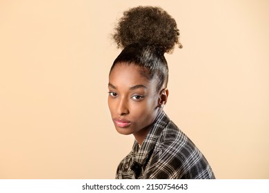 Attractive Dominican Female Model With Black Hair In Stylish Checkered Shirt Looking At Camera Against Beige Background In Light Studio