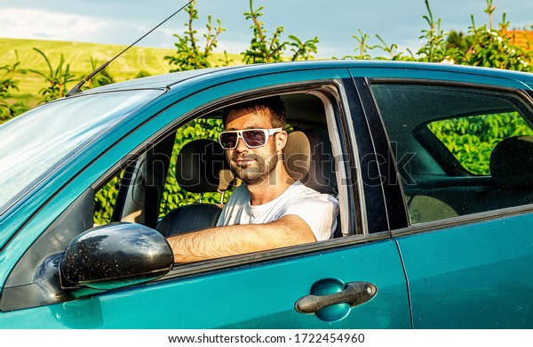 Attractive elegant happy man
in a car.
