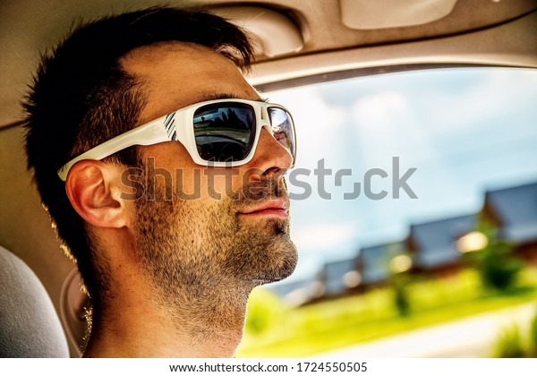 Attractive elegant happy man\
in a car.