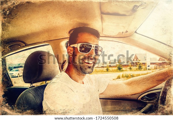 Attractive\
elegant happy man in a car, old photo\
effect.