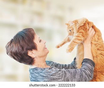 attractive emotional woman 50 years old with red cat  - Powered by Shutterstock