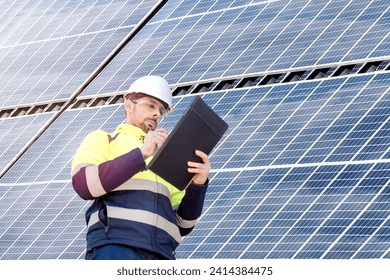 Attractive engineer installing solar panels and clean energy - Powered by Shutterstock