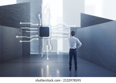 Attractive European Man Standing In Concrete Interior With Abstract Micro Chip And Mock Up Place. AI And Technology Concept