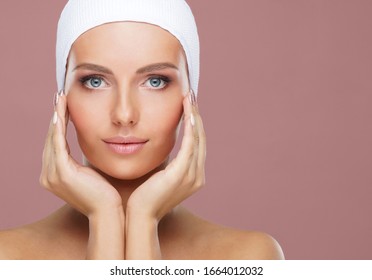 Attractive face of beautiful girl. Close-up portrait of healthy woman. Skin care, cosmetics, makeup, complexion and face lifting.
