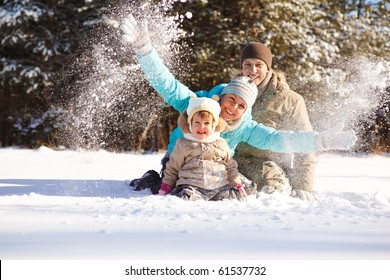 Attractive Family Having Fun In A Winter Park