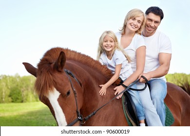 Attractive Family On A Brown Horse